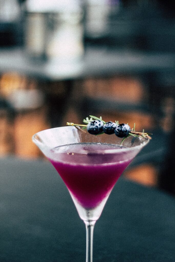 Queen Garnet Cosmo Queen sitting in a classy cocktail glass